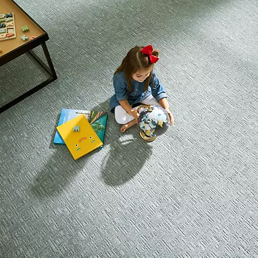 Child playing on a carpet floor